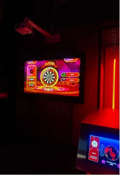 Group enjoying darts, drinks, and delicious food from Smokey Trotters at Golf Fang in Glasgow.