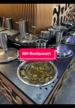 Vibrant African-Caribbean buffet featuring jerk chicken, curry goat, and plantains at M4 Caribbean Restaurant, Manchester.