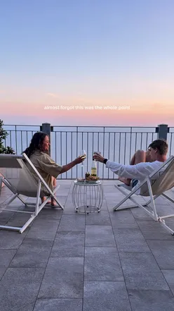 Sunset view with wine and snacks at Hotel Due Gemelli, Italy, overlooking mountains and sea in Riomaggiore, Cinque Terre.