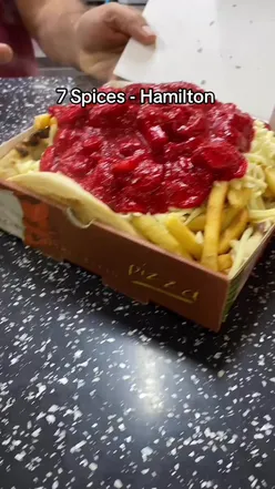 Chips topped with cheese and Chicken Chasni from 7 Spices restaurant